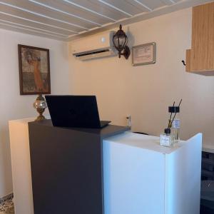 a desk with a laptop computer on top of it at Hera Pansiyon in Ayvalık