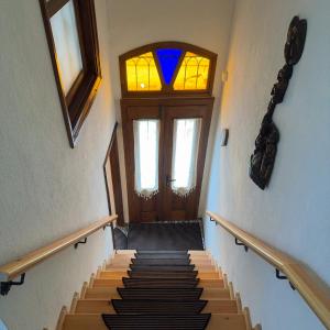a set of stairs with a door and a window at Hera Pansiyon in Ayvalık