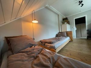 a bedroom with two beds in a room at Unikt skipperhus med høner i hagen in Hvaler