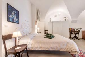 a bedroom with a bed and a table and chairs at Casa Ipogea Elegant Apartment in Bergamo