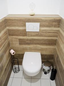 a white toilet in a bathroom with wooden walls at Appart T2 cabine 5 min du centre in Le Touquet-Paris-Plage
