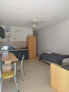 a room with a bed and a table and a desk at Brisas del Lago Apartamentos in Colón +41 photos