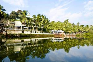 a resort with palm trees and a body of water at Casa Colvale in Mapusa
