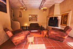 a living room with leather furniture and a fireplace at Maison provençale avec jardin in Velleron +15 photos