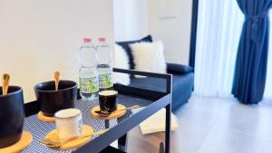 a table with two bottles of water and two cups at Ca Teresa Ebano by Ca-Sa Check in Chioggia +46 photos