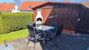 a patio with a table and chairs in front of a building at Ferienwohnung Plogmann - Residenz Bernstein WHG 39 in Rerik