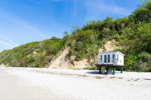 a small house sitting on a stand on a beach at Ferienwohnung Plogmann - Residenz Bernstein WHG 39 in Rerik