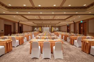 a large banquet hall with tables and white chairs at InterContinental Bali Resort by IHG in Jimbaran