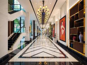 a hallway with a tile floor and a chandelier at InterContinental Bali Resort by IHG in Jimbaran