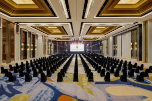 an empty conference room with chairs and a screen at InterContinental Bali Resort by IHG in Jimbaran