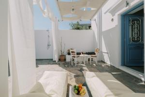 a living room with a couch and a blue door at Aegean Nest in Koskinou