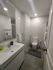 a white bathroom with a sink and a toilet at Hostel Aveiro in Aveiro +85 photos