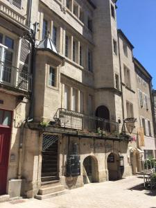 a large building with a balcony on the side of it at La Parenthèse Comtoise in Dole