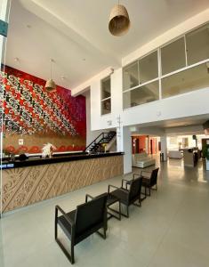 a lobby with chairs and a wall with a painting at Mochican Palace Hotel in Huanchaco +67 photos