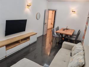 a living room with a television and a table at Tbilisi LUXURY APARTMENT in Tbilisi City