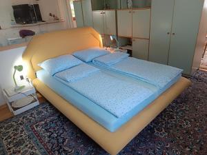 a bed with blue pillows on it in a room at Bolero apartman in Sarajevo