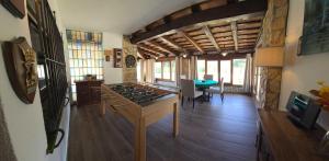 a living room with a stove and a table at Costabravasuites Villa Los Vientos in Calella de Palafrugell