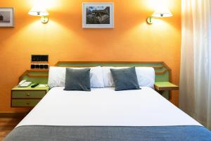 A bed or beds in a room at Hotel Alda Guijuelo