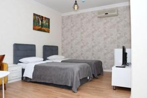 a bedroom with a bed and a tv in it at Arena Hotel Gazakh in Qazax +25 photos