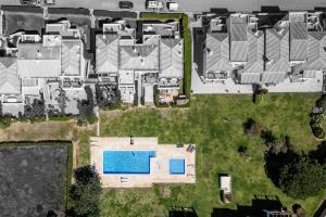an aerial view of a house with a swimming pool at The Golden Breeze – Beachside Pool & BBQ Escape in Faro