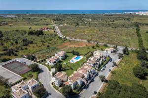 an aerial view of a villa with a road and houses at The Golden Breeze – Beachside Pool & BBQ Escape in Faro