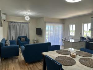 BuccooにあるNova Havenのテーブルと椅子、キッチンのあるリビングルーム