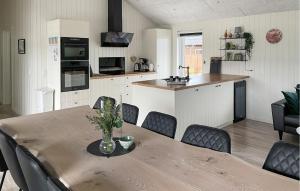 a kitchen and dining room with a table and chairs at Stunning Home In Hadsund With Five Bedrooms And Wifi in Hadsund