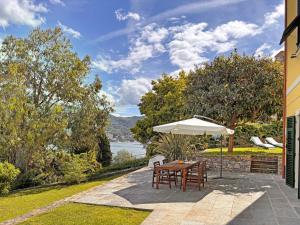 a patio with a table and an umbrella at Villa Viola in Rapallo