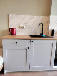 a white kitchen counter with a sink and a counter top at Apartament Centrum Kłodzko - Stara i Piękna Kamienica - ulica Okrzei, Spokój, Parking, 25m2 in Kłodzko