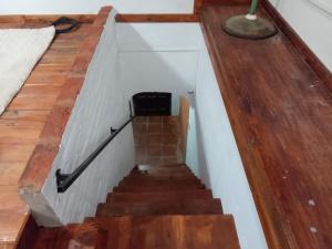 a staircase in a house with wooden floors and a stair case at Mikasa in La Porteña