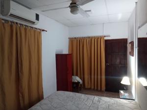 a bedroom with a bed and a brown curtain at Mikasa in La Porteña