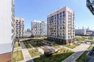 an aerial view of a city with tall buildings at Nexpo city apartments near Expo in Stroitelʼnyy