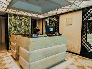 a man sitting at a counter in a restaurant at Hotel President - Vintage Hotel in centro in Riccione