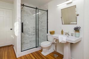 a bathroom with a shower and a toilet and a sink at The Royce on Spring - High-End Family Getaway in Newport in Newport