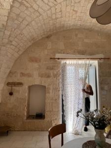 a room with a stone wall and a window at Ma'Bella - MASSERIA PICCOLA by Rentbeat in Cisternino +33 photos
