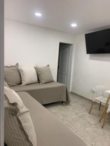 a living room with a couch and a flat screen tv at Esquel Home in Esquel