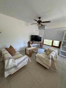 a living room with two beds and a television at Posada de San Isidro in San Isidro