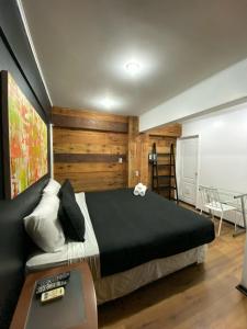 a bedroom with a bed and a desk and a table at Tremo Bustamante in Santiago