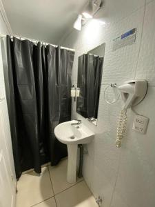 a bathroom with a sink and a shower curtain at Tremo Bustamante in Santiago +33 photos