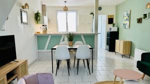 a kitchen and dining room with a table and chairs at Chez Mag maison de pêcheur proche plage in Ault +13 photos