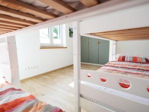 an attic bedroom with two beds and a window at Conzen Hof am Hennesee in Meschede