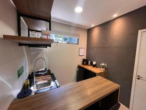 a kitchen with a sink and a counter top at RASTRO Cabins in Restinga Sêca
