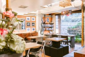 a restaurant with tables and chairs and a book shelf at Diamond House Khaosan in Bangkok