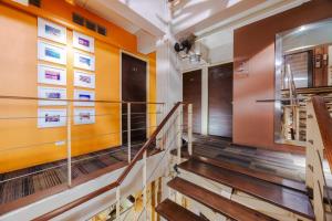 a staircase in a building with orange walls at Diamond House Khaosan in Bangkok +20 photos