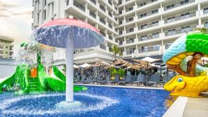 a pool with a water park in front of a building at Bonita Luxury Resort & Spa in Durrës