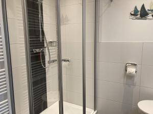 a shower with a glass door in a bathroom at Berolina 316 - Möwennest in Dahme +31 photos