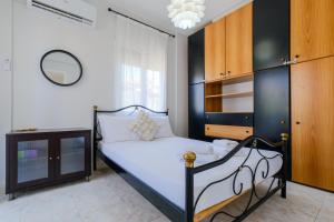 a bedroom with a black and white bed and a mirror at Hidden Pine in Pefkohori