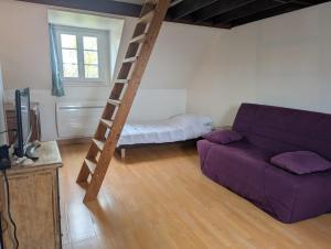 a living room with a purple couch and a bunk bed at Chez Camille in Dives-sur-Mer
