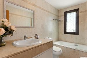 a bathroom with a sink and a toilet and a mirror at Golf Hills in Estepona
