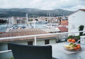 a bowl of fruit on a table on a balcony at Villa Angel sea view in Trogir